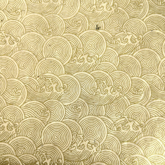 Nepalese handmade decorative lokta paper sheet with a metallic gold wave design screen printed on an ivory lokta paper.