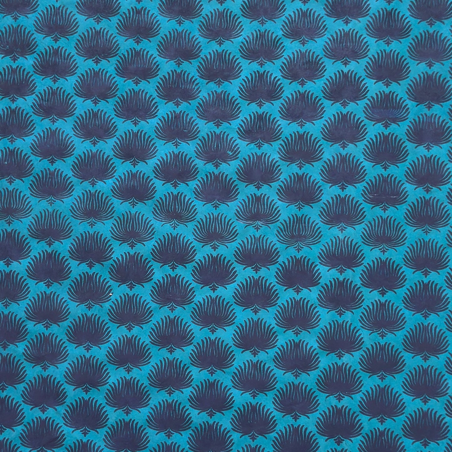 Nepalese handmade decorative lokta paper sheet with an inky blue palm leaf design screen printed on a teal lokta paper.