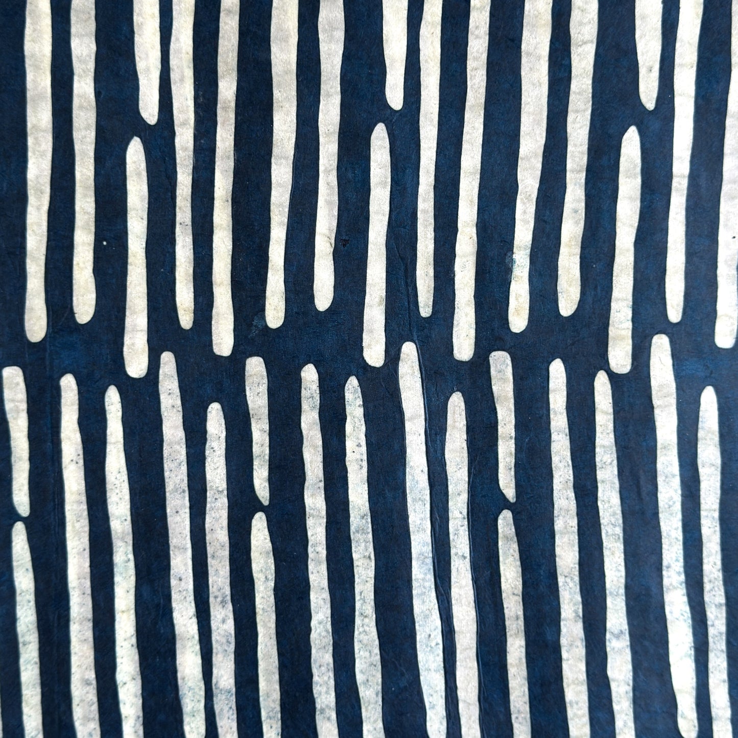 Nepalese handmade decorative lokta paper sheet with a stripe pattern in petrol blue and white.  Batik dyed using carved wooden blocks