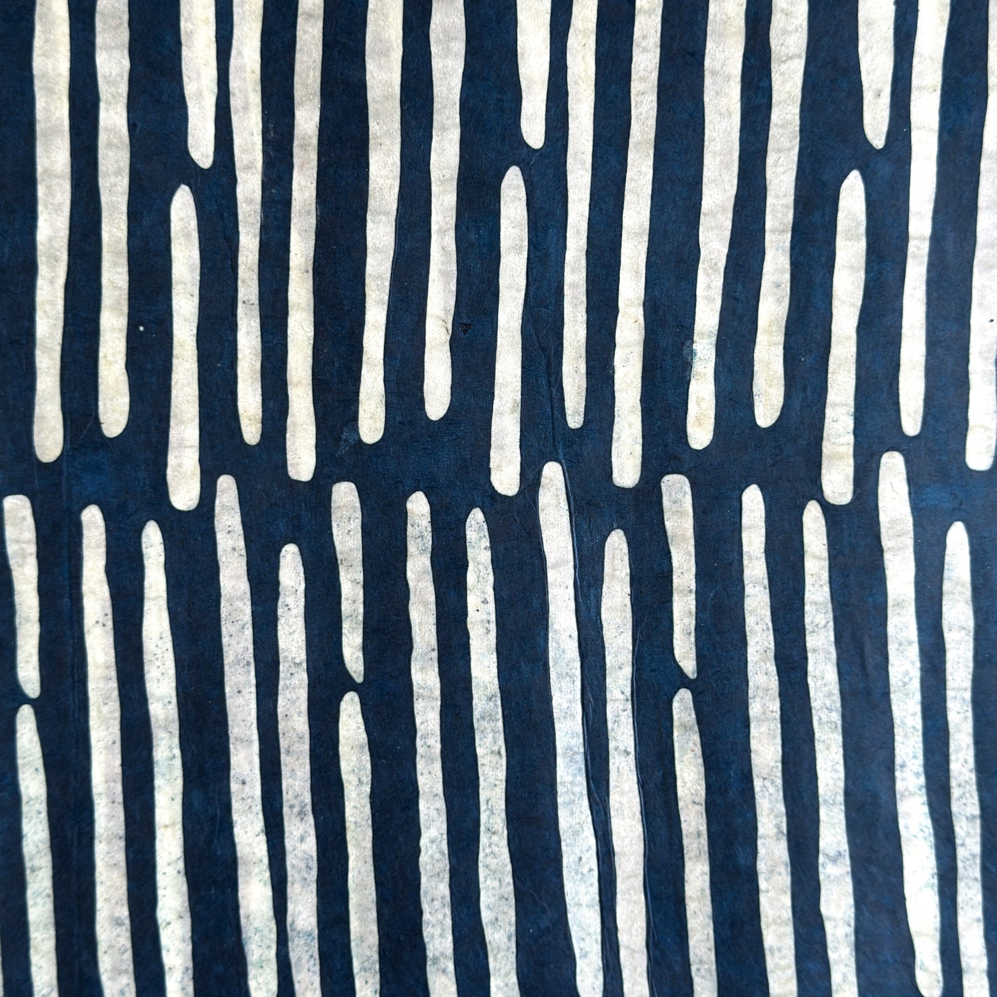 Nepalese handmade decorative lokta paper sheet with a stripe pattern in petrol blue and white.  Batik dyed using carved wooden blocks