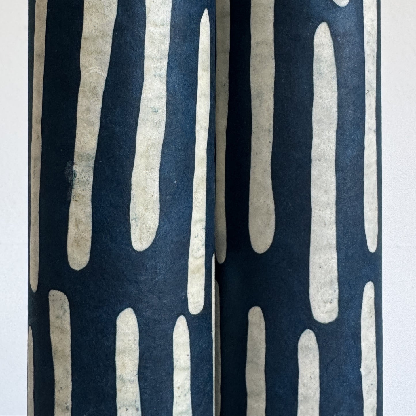 Nepalese handmade decorative lokta paper sheet with a stripe pattern in petrol blue and white.  Batik dyed using carved wooden blocks. Close up