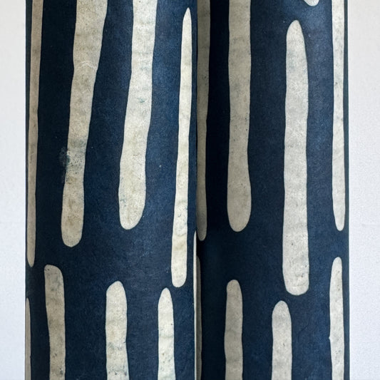 Nepalese handmade decorative lokta paper sheet with a stripe pattern in petrol blue and white.  Batik dyed using carved wooden blocks. Close up