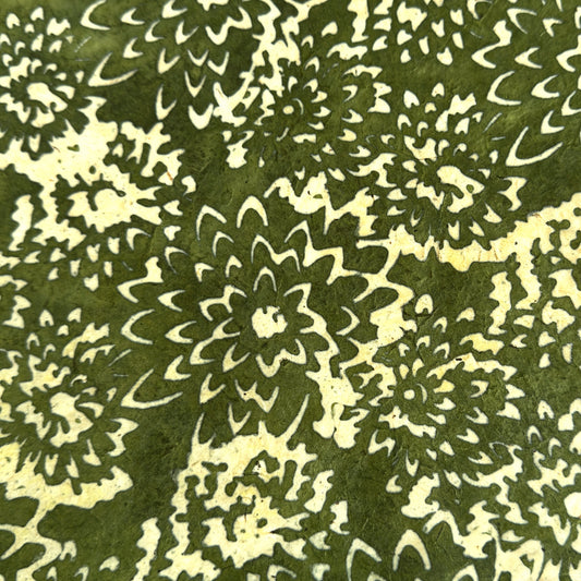 Nepalese handmade decorative lokta paper sheet with a floral pattern in green and cream.  Batik dyed using carved wooden blocks.