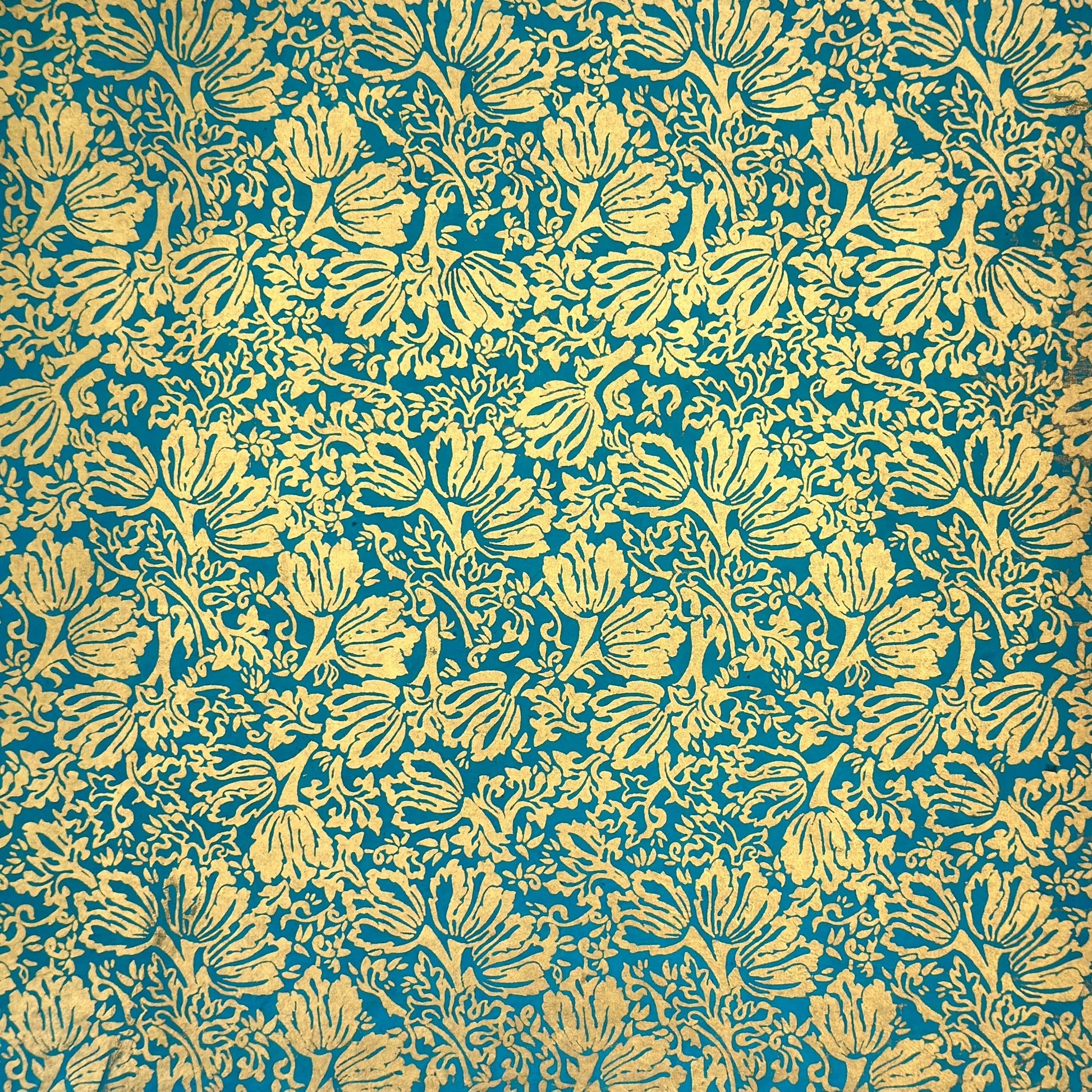 Nepalese handmade decorative lokta paper sheet with a metallic gold tulip design screen printed on a teal lokta paper.