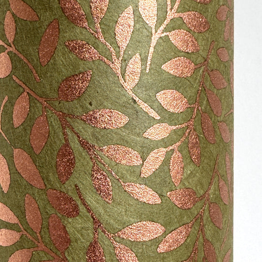 Nepalese handmade decorative lokta paper sheet with a metallic copper willow design screen printed on a dusty moss green lokta paper. Close up