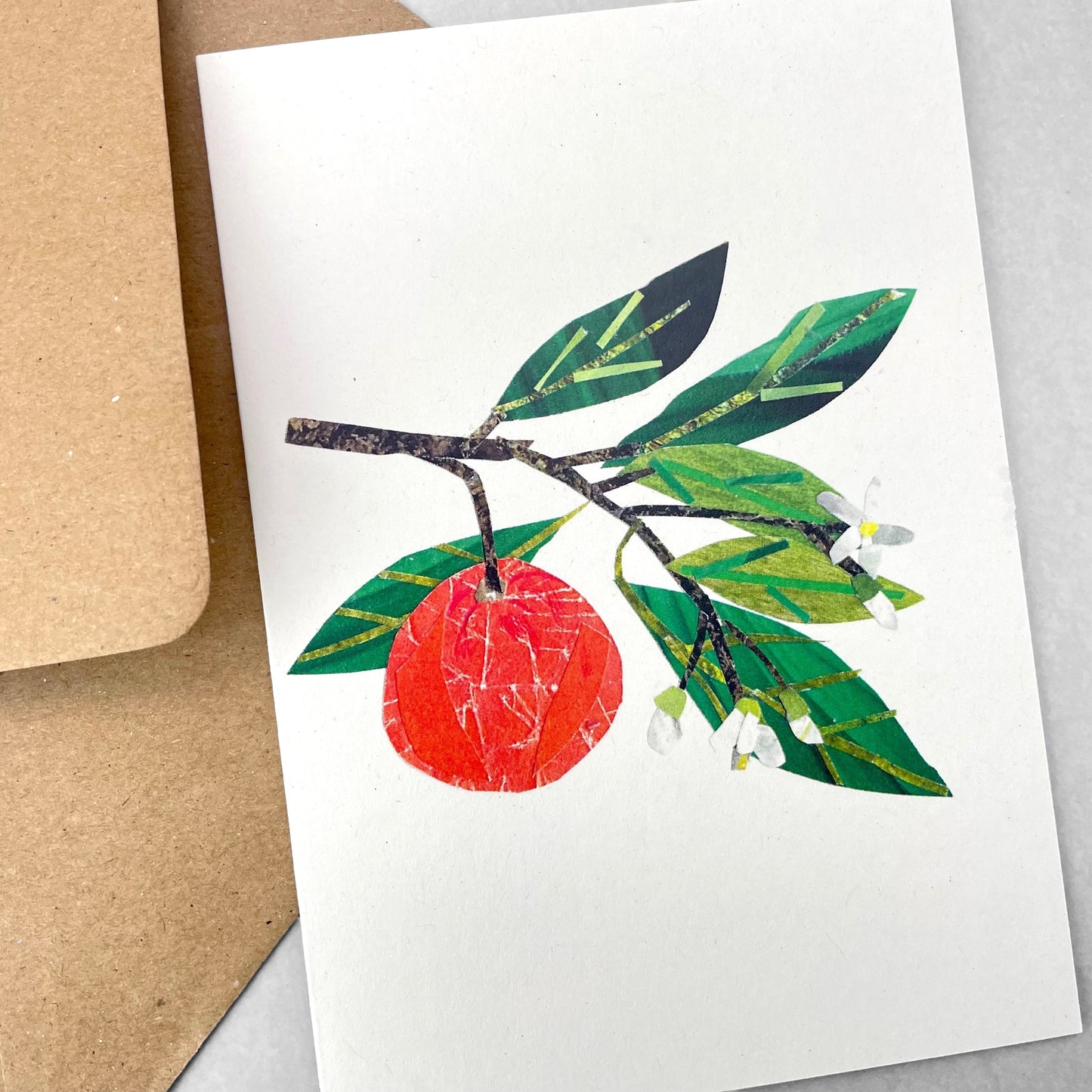 Greetings card by Megan Fartharly of a collaged orange, with envelope