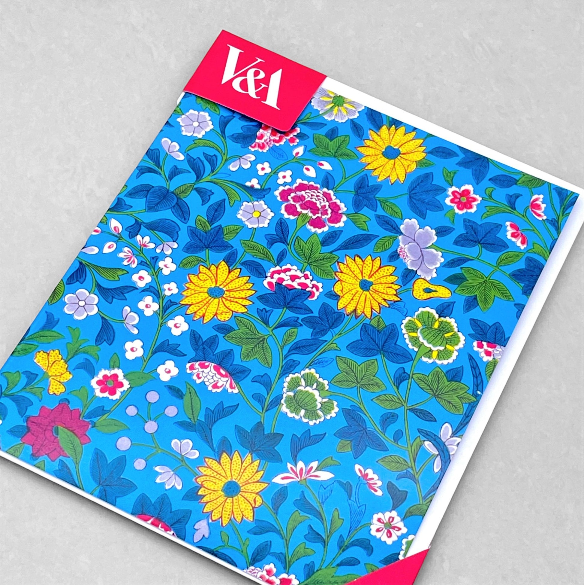 greetings card showing a floral repeat pattern on a blue background