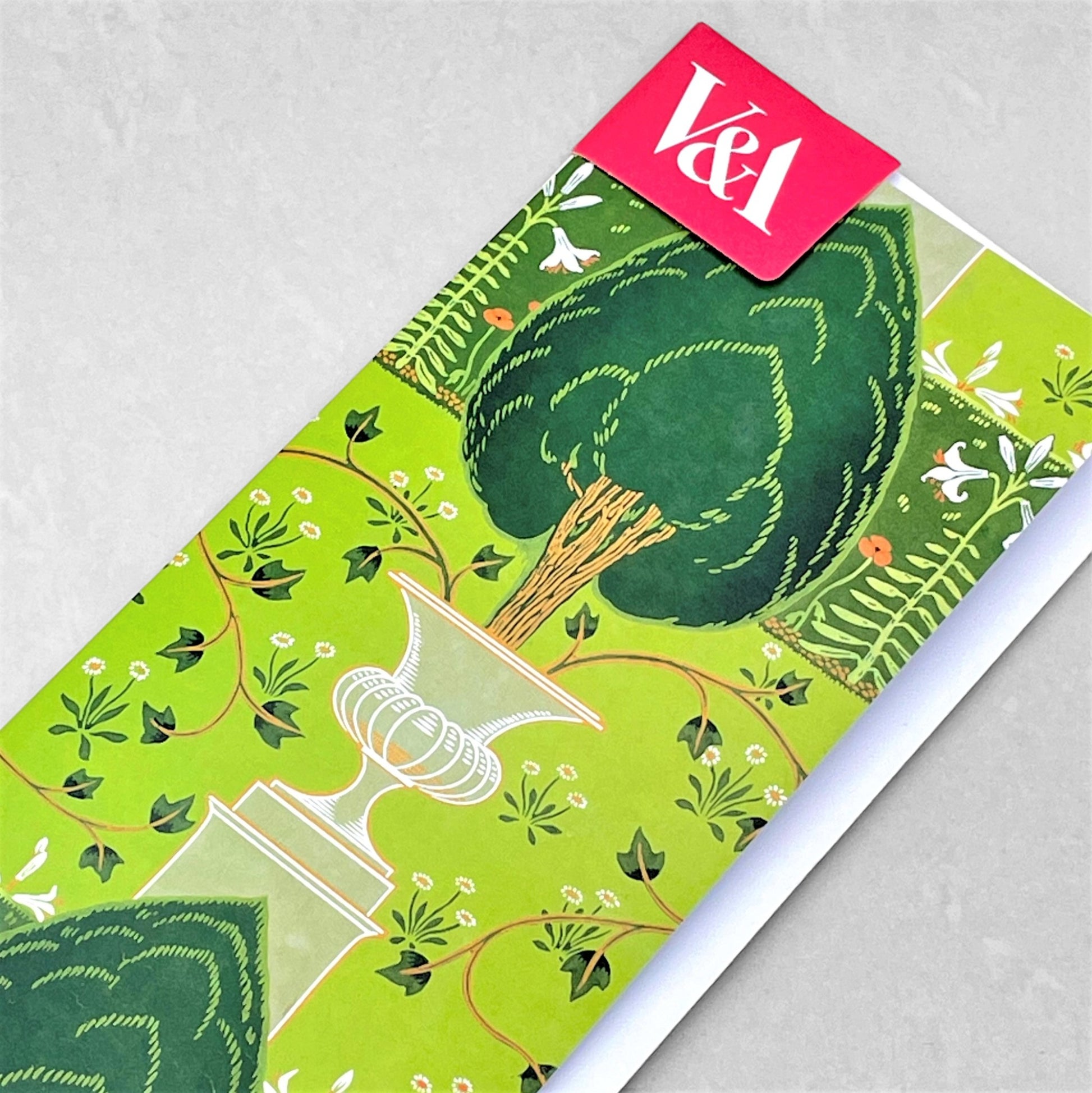 greetings card showing a tree planted in a decorative pot on a green backdrop