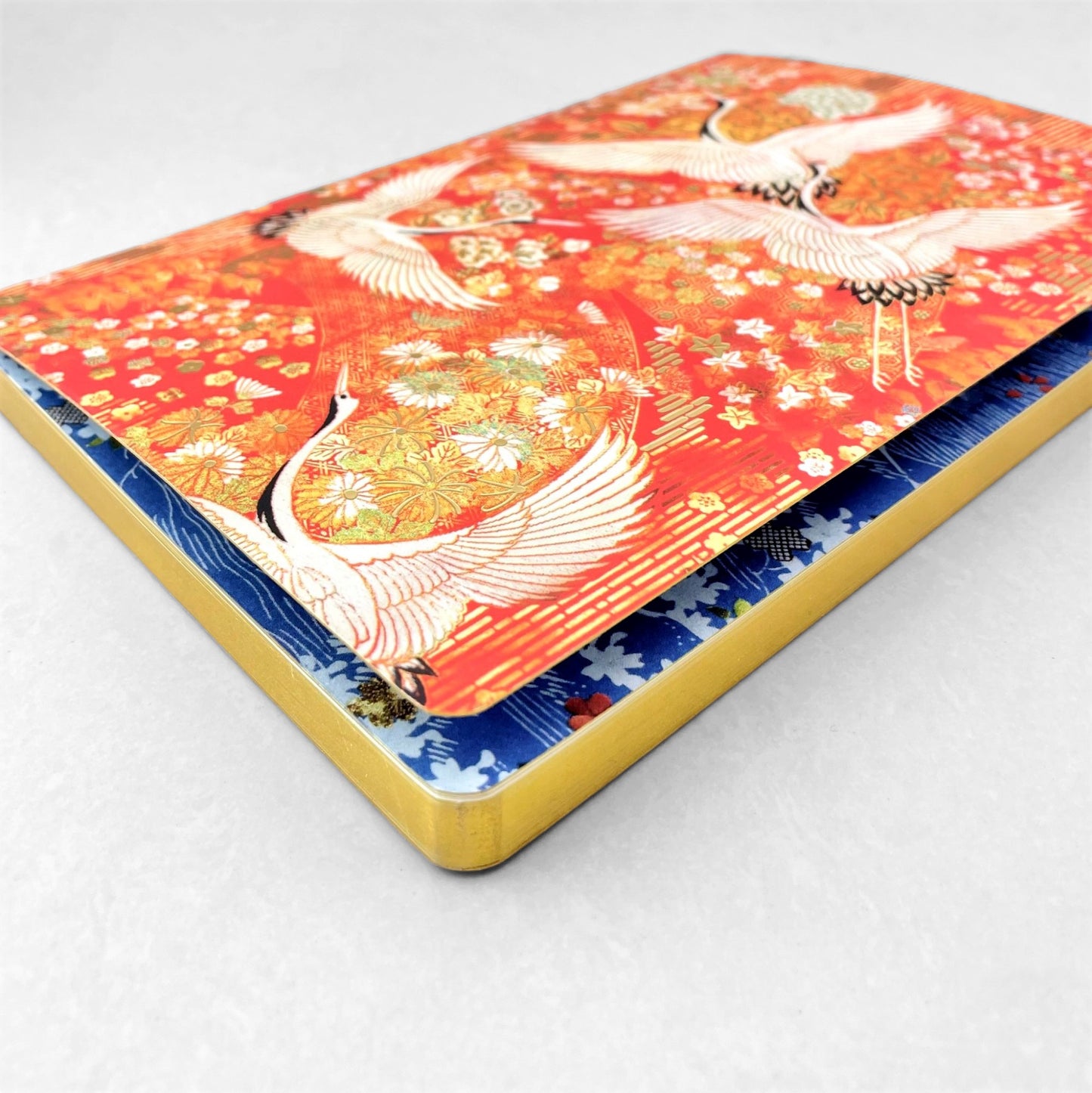 A5 lined notebook with a japanese cover design with white swans on an orange background