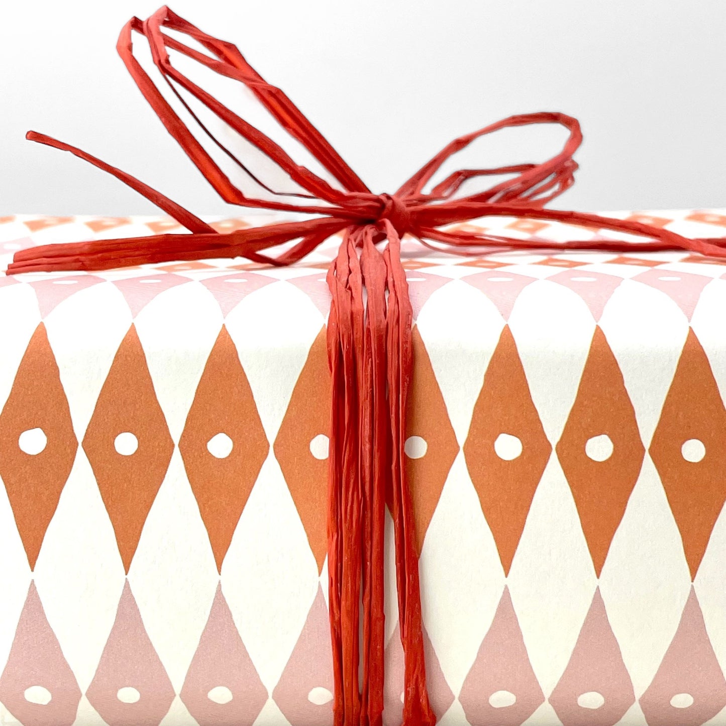 Bold coral orange hank of natural raffia by Nutscene