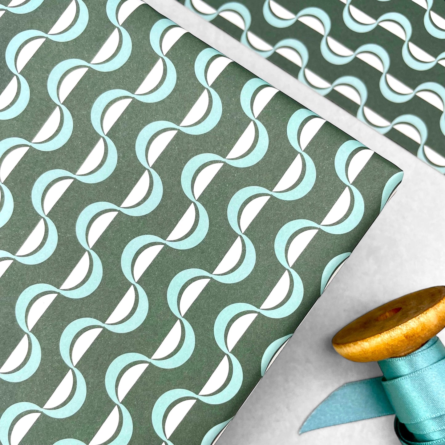wavy striped geometric wrapping paper in forest green, aqua and white, by Ola Studio forest, close up