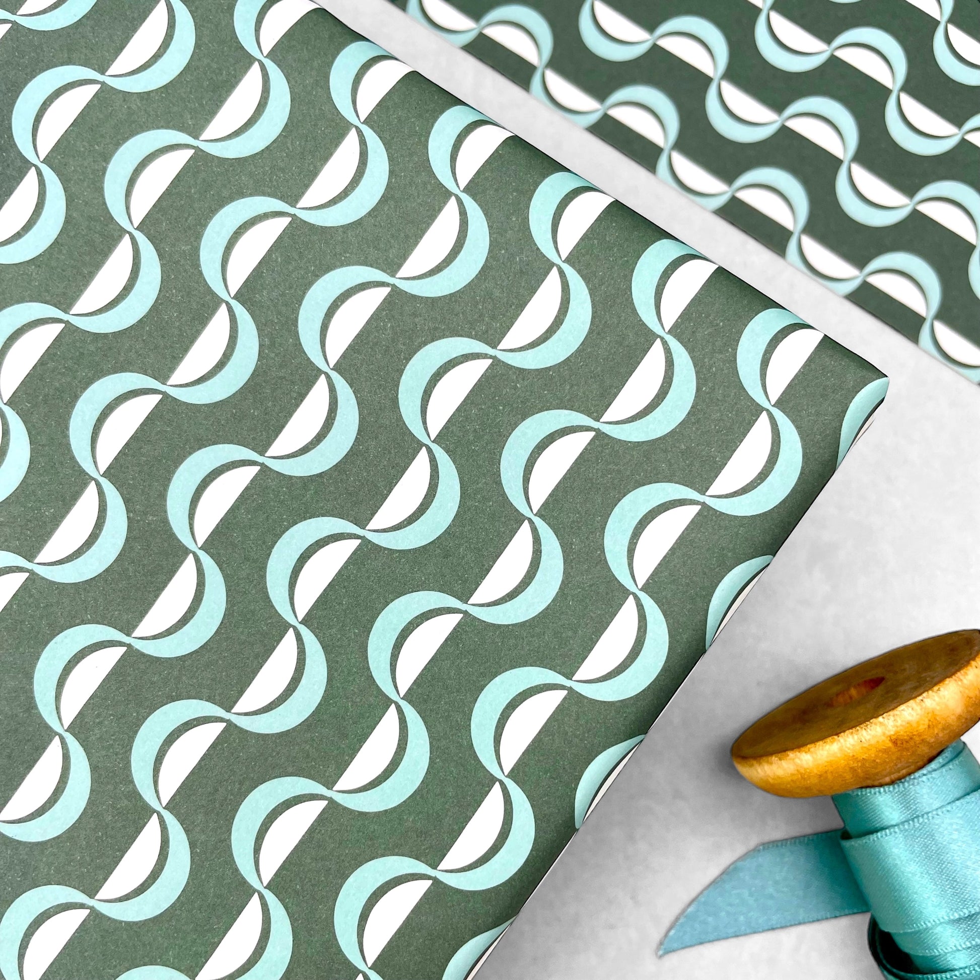 wavy striped geometric wrapping paper in forest green, aqua and white, by Ola Studio forest, close up