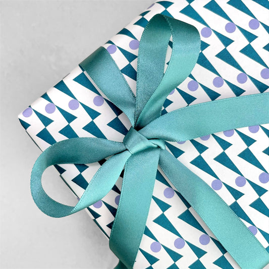 Luxury calamine blue satin ribbon on a rectangular board by Ola Studio, shown as a bow