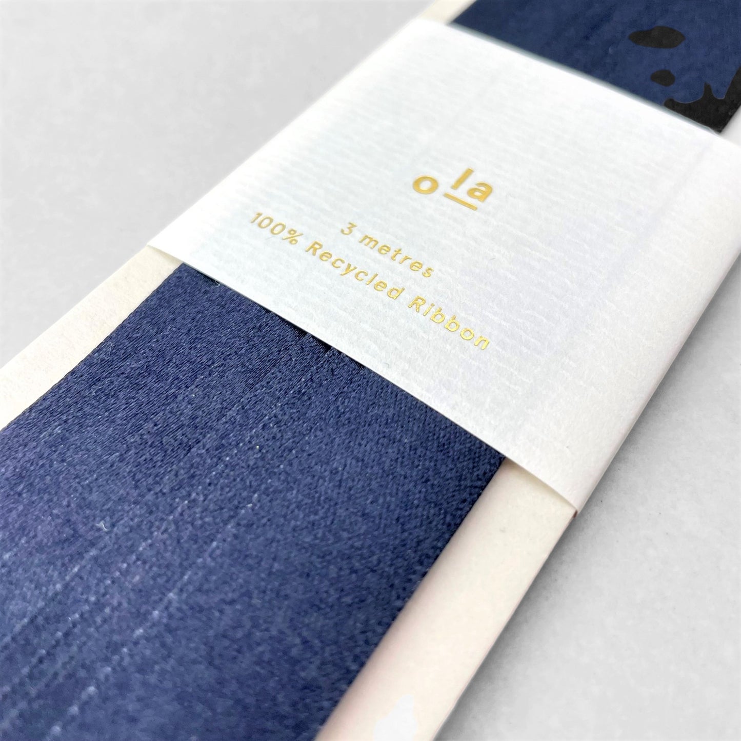 Luxury dark navy satin ribbon on a rectangular board, by Ola Studio