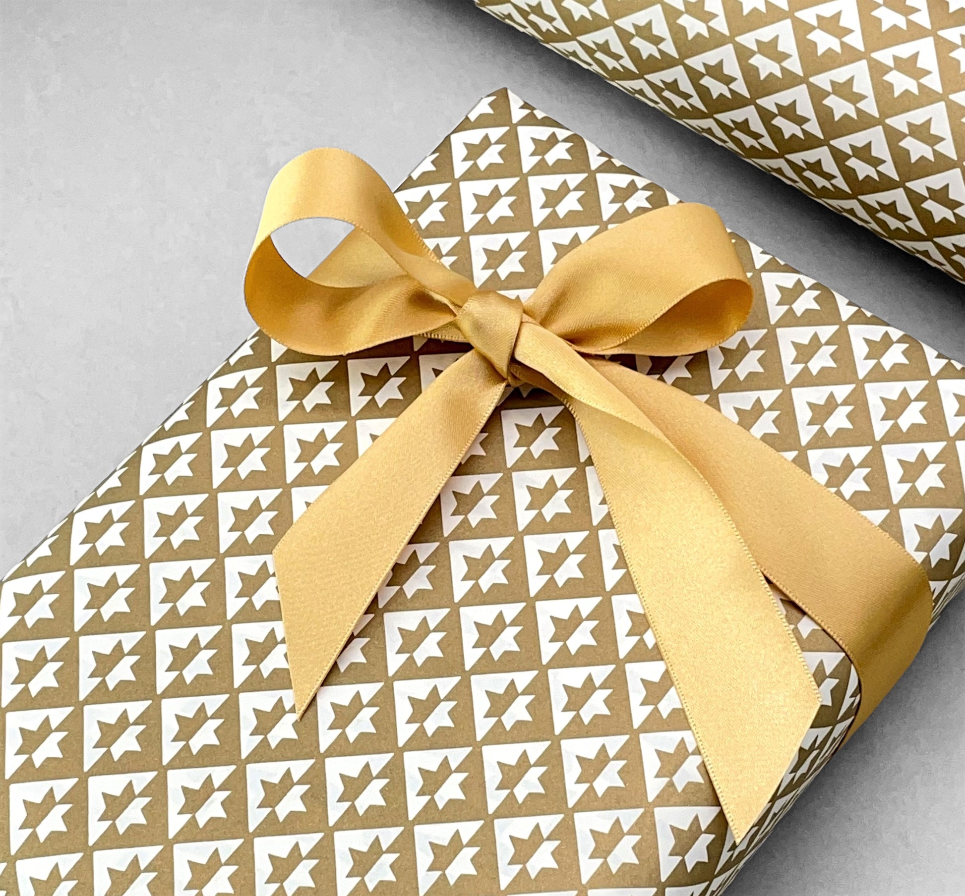 wrapping paper with an abstract star pattern in gold and white by Ola Studio