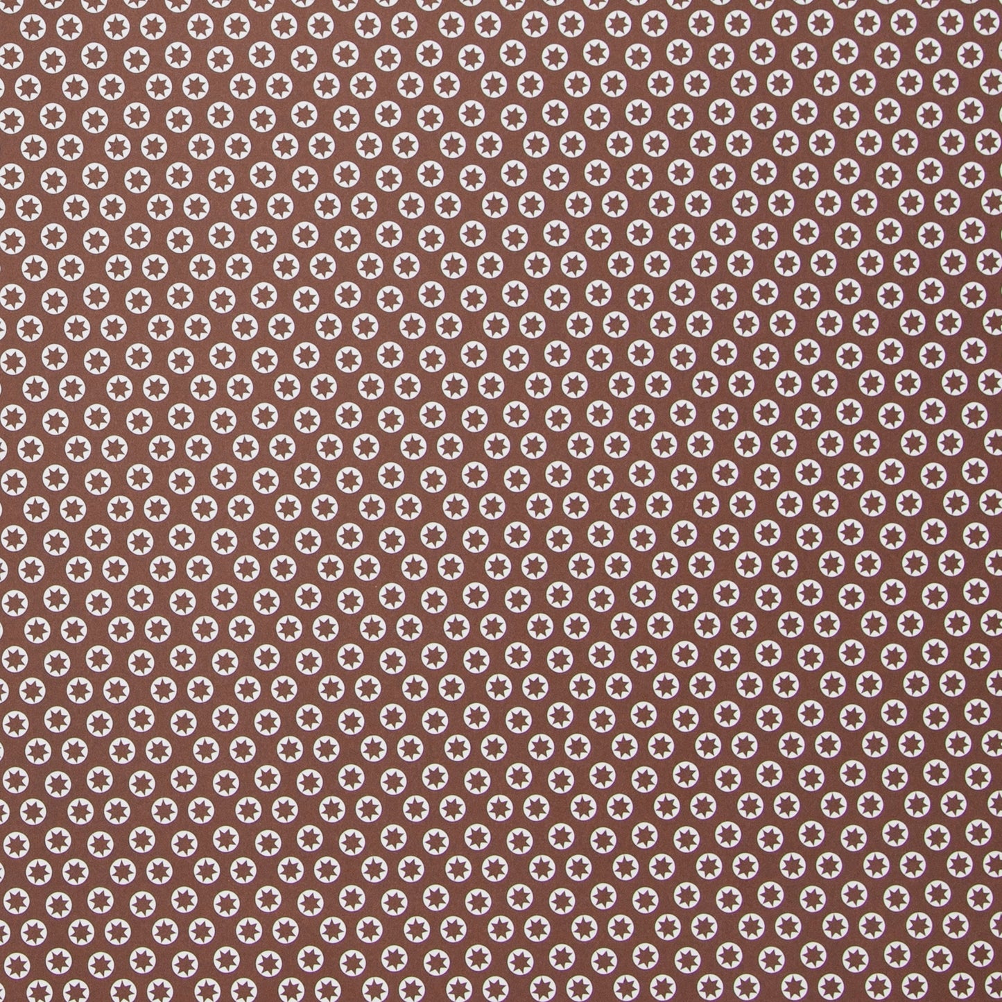 wrapping paper with an abstract tiny stars pattern in chestnut brown and white by Ola Studio