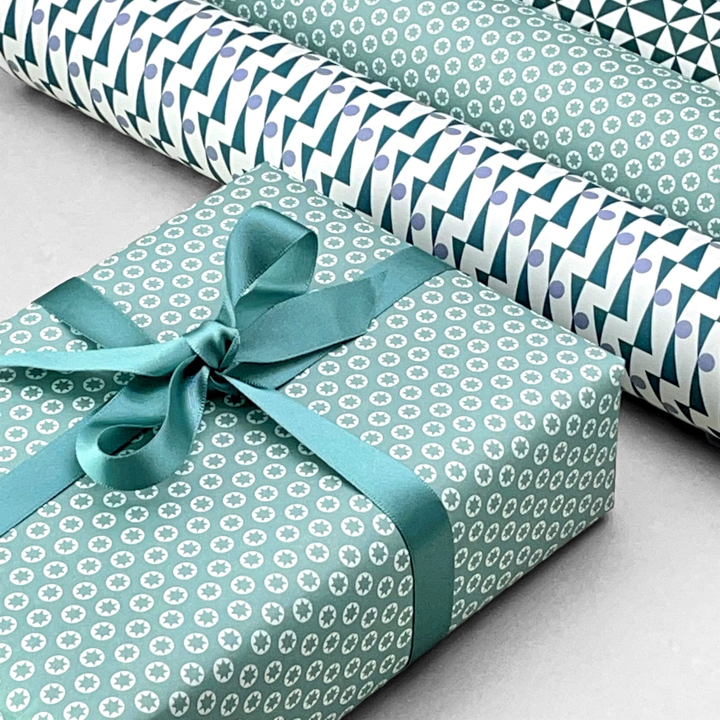 wrapping paper with an abstract tiny stars pattern in ice blue and white by Ola Studio