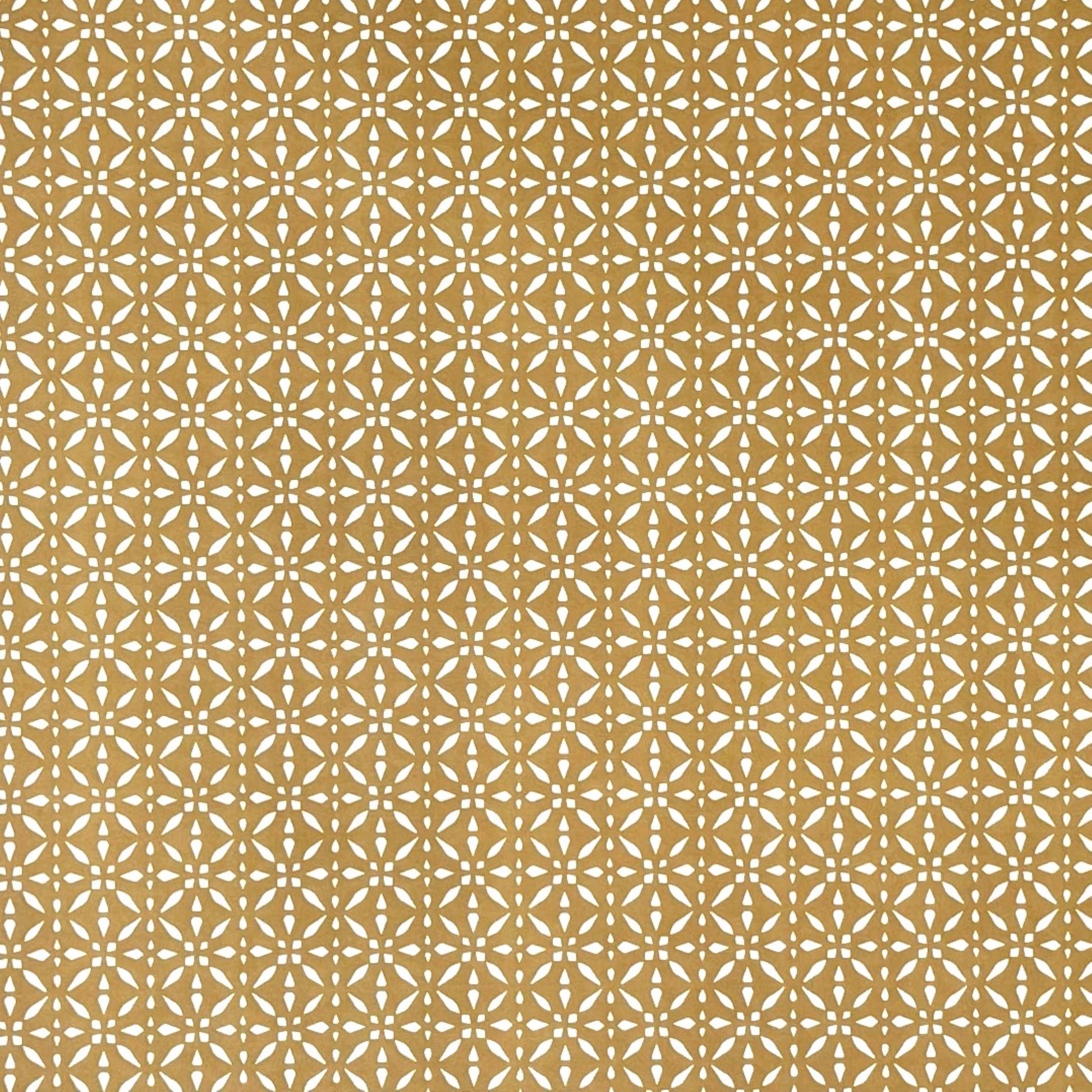 wrapping paper by Otto Editions with a cut-out design in white on a gold background.