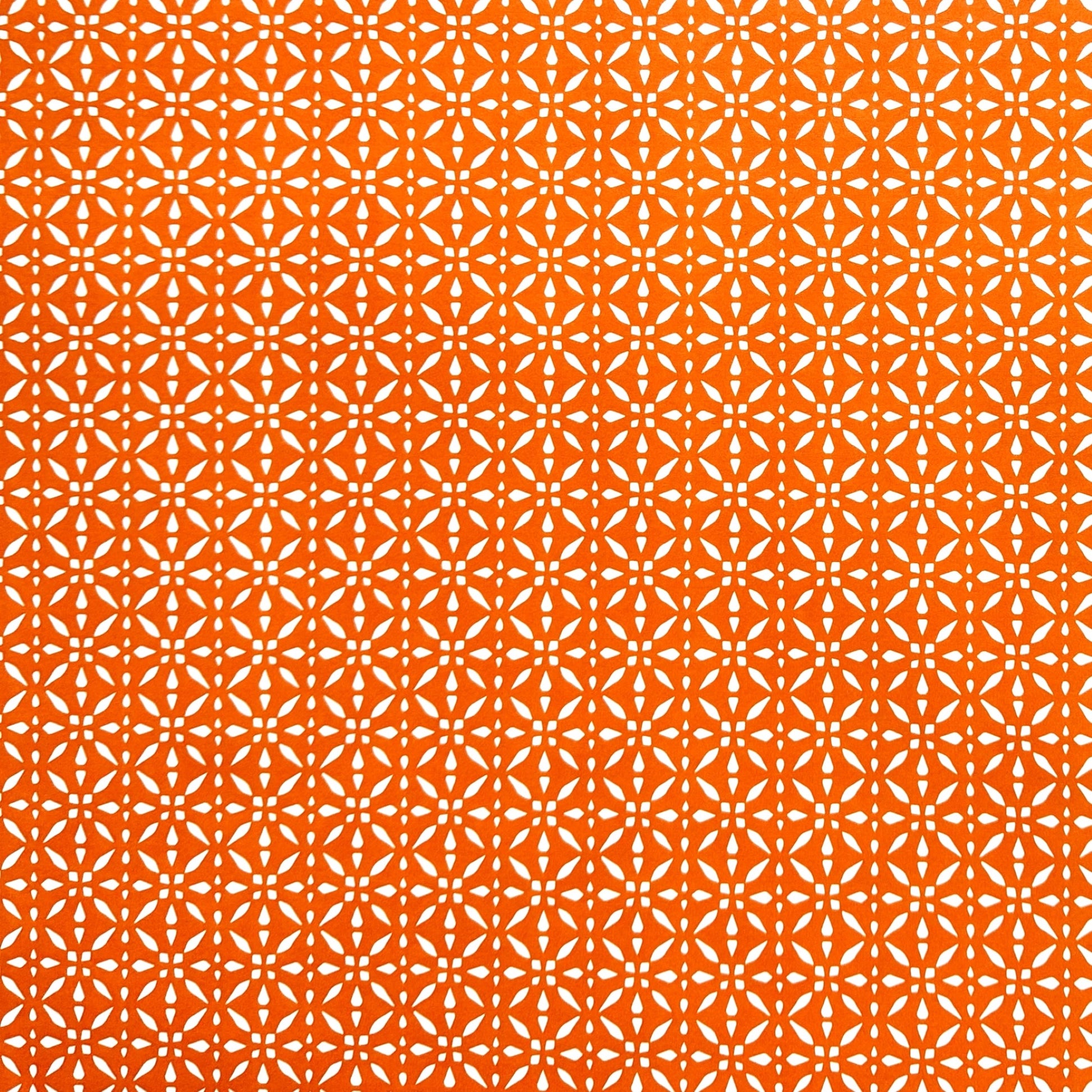 wrapping paper by Otto Editions with a cut-out design in white on a spice orange background.
