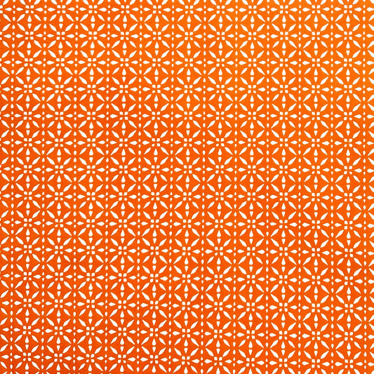 wrapping paper by Otto Editions with a cut-out design in white on a spice orange background.