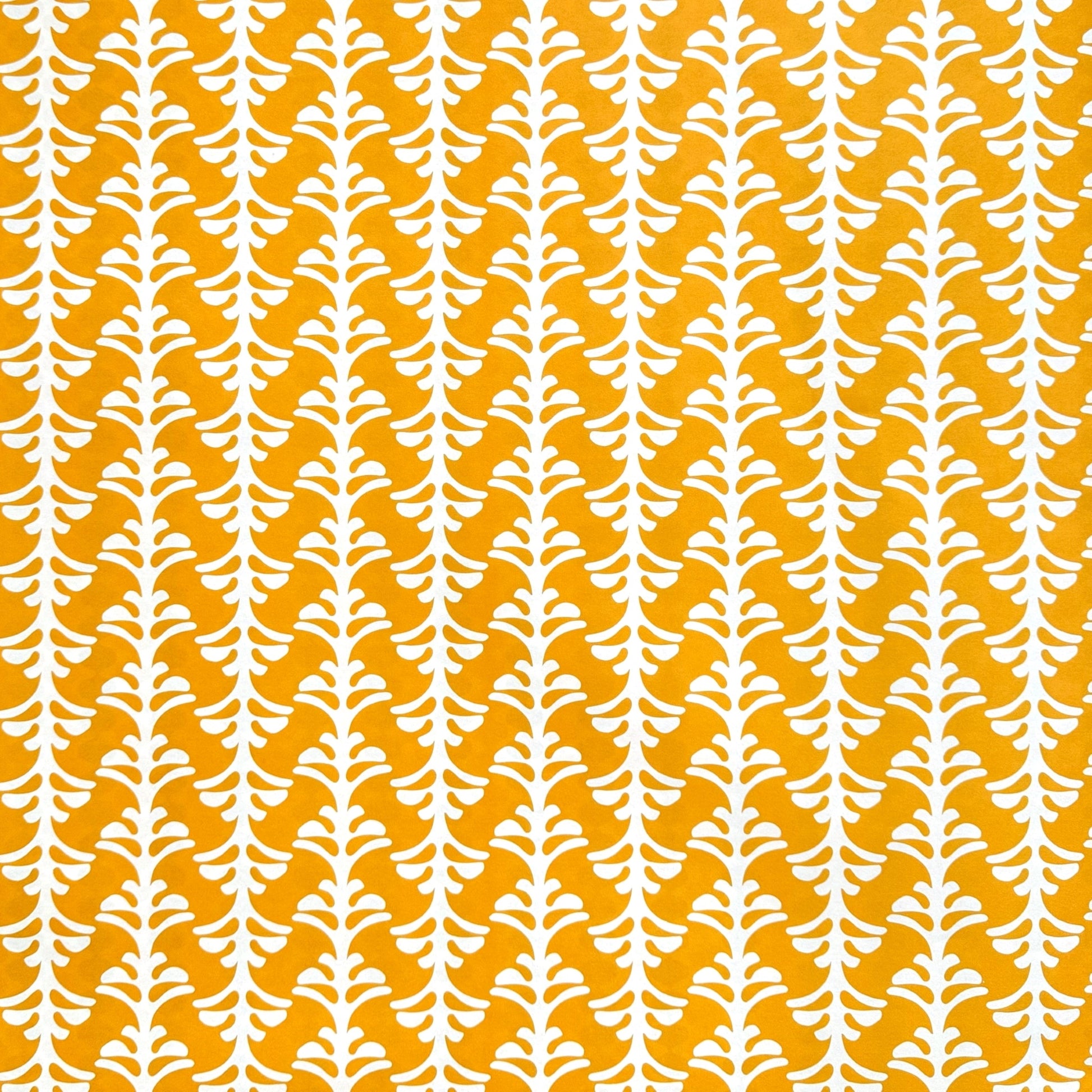 wrapping paper by Otto Editions with a cut-out palm design in white on a saffron yellow background.