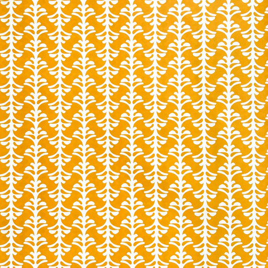 wrapping paper by Otto Editions with a cut-out palm design in white on a saffron yellow background.