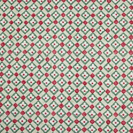 Hand block printed wrapping paper with a floral checked pattern in sage green and red.