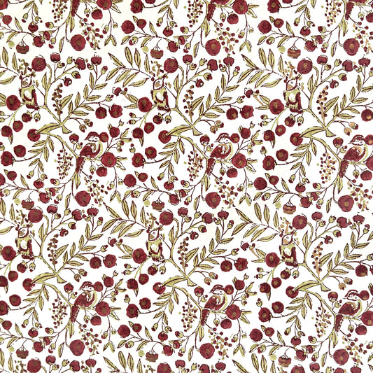 a sheet of hand block printed paper with a repeat pattern of foliage, flowers and a songbird in red, green and gold
