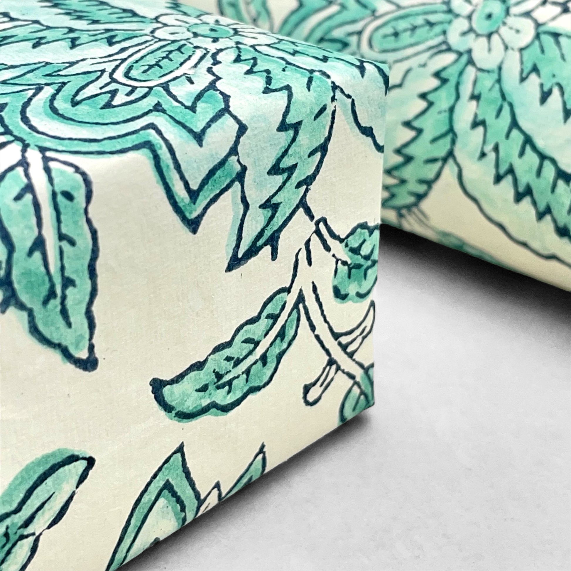 wrapping paper with repeat botanical floral pattern in light aqua by Paper Mirchi