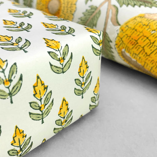Wrapping paper with block print small flower motif in yellow and green, white background by Paper Mirchi