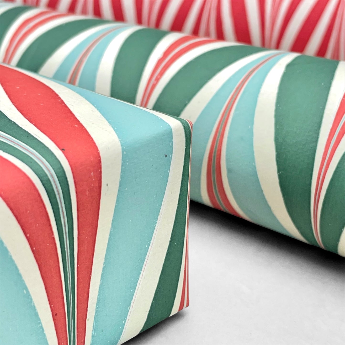 wrapping paper with marbled chevron pattern in red, green and aqua by Paper Mirchi