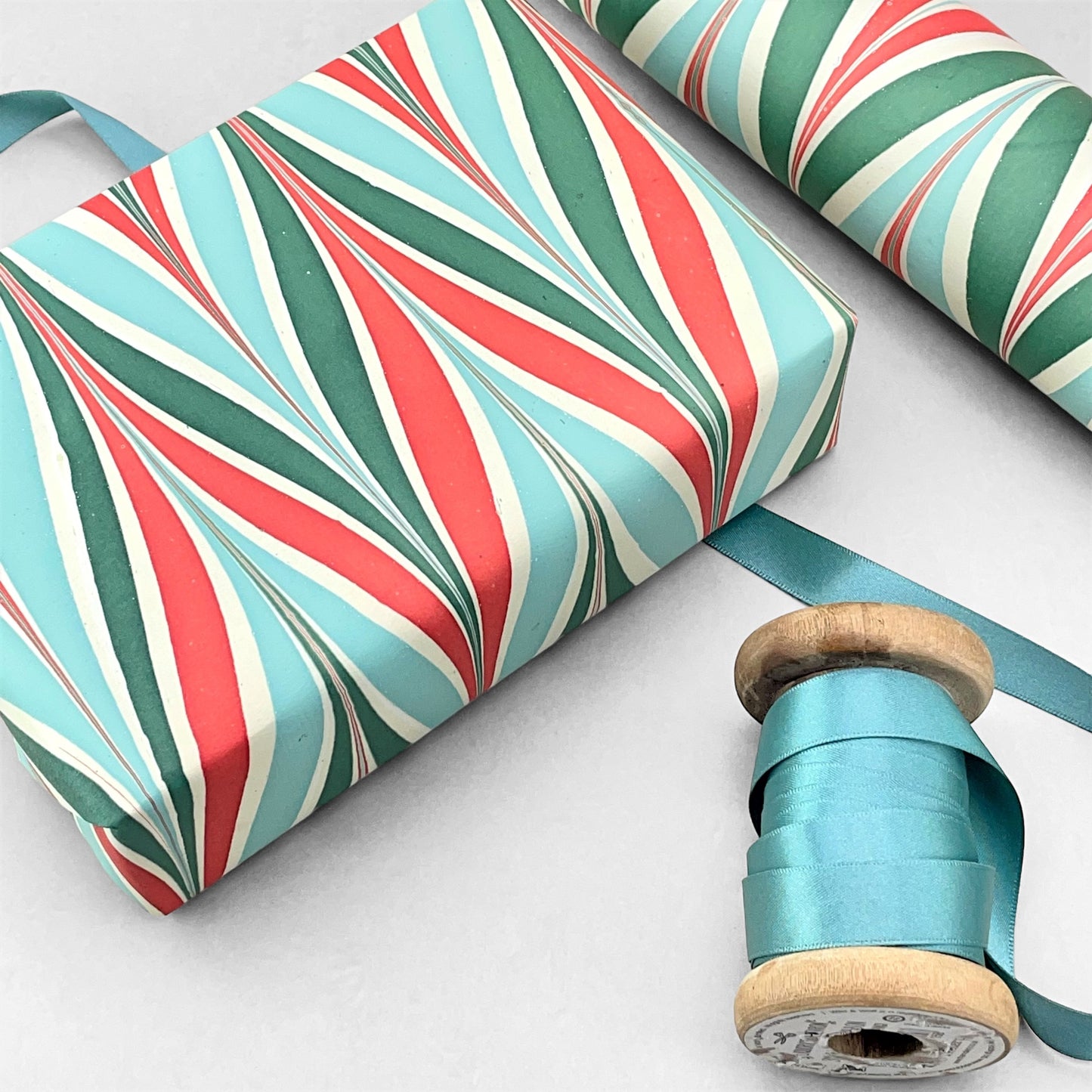 wrapping paper with marbled chevron pattern in red, green and aqua by Paper Mirchi