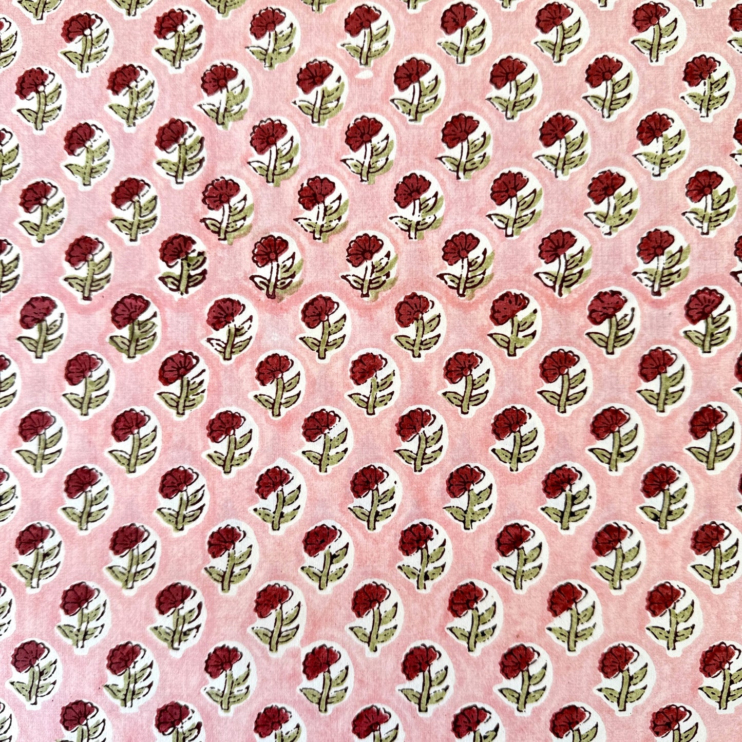 hand block printed patterned paper by Paper Mirchi, red daisy print on pink background