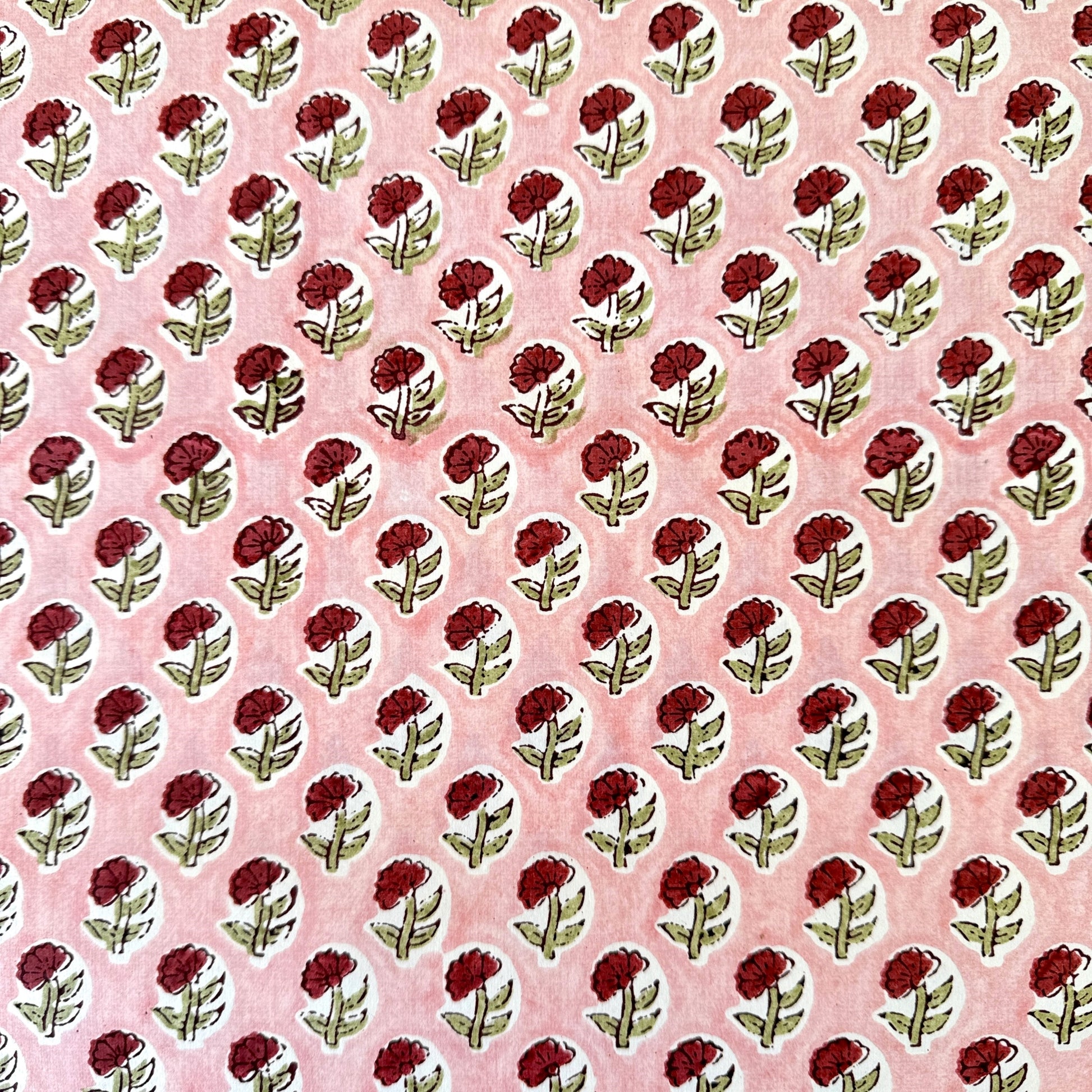 hand block printed patterned paper by Paper Mirchi, red daisy print on pink background