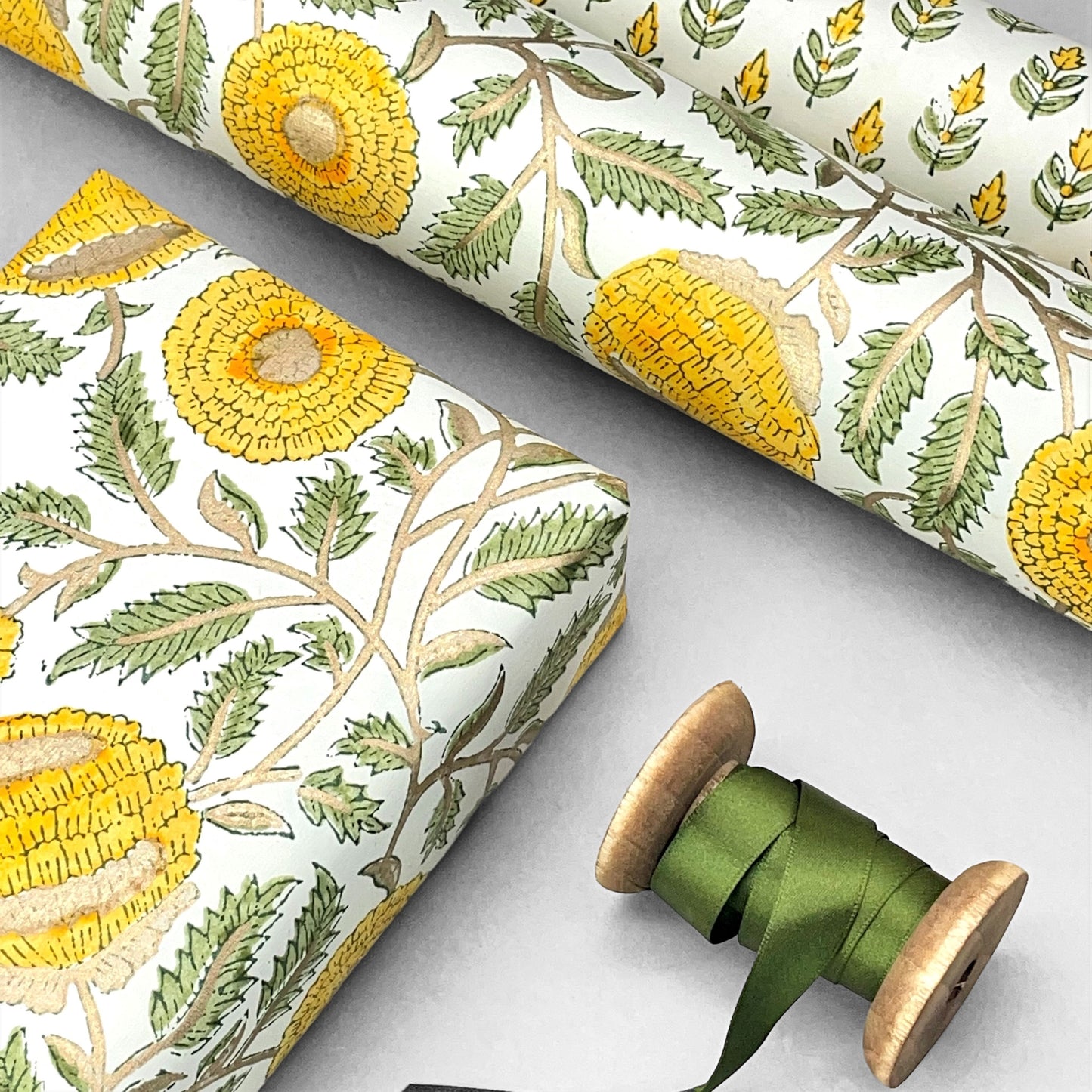 wrapping paper with repeat botanical pattern in yellow, gold and green by Paper Mirchi