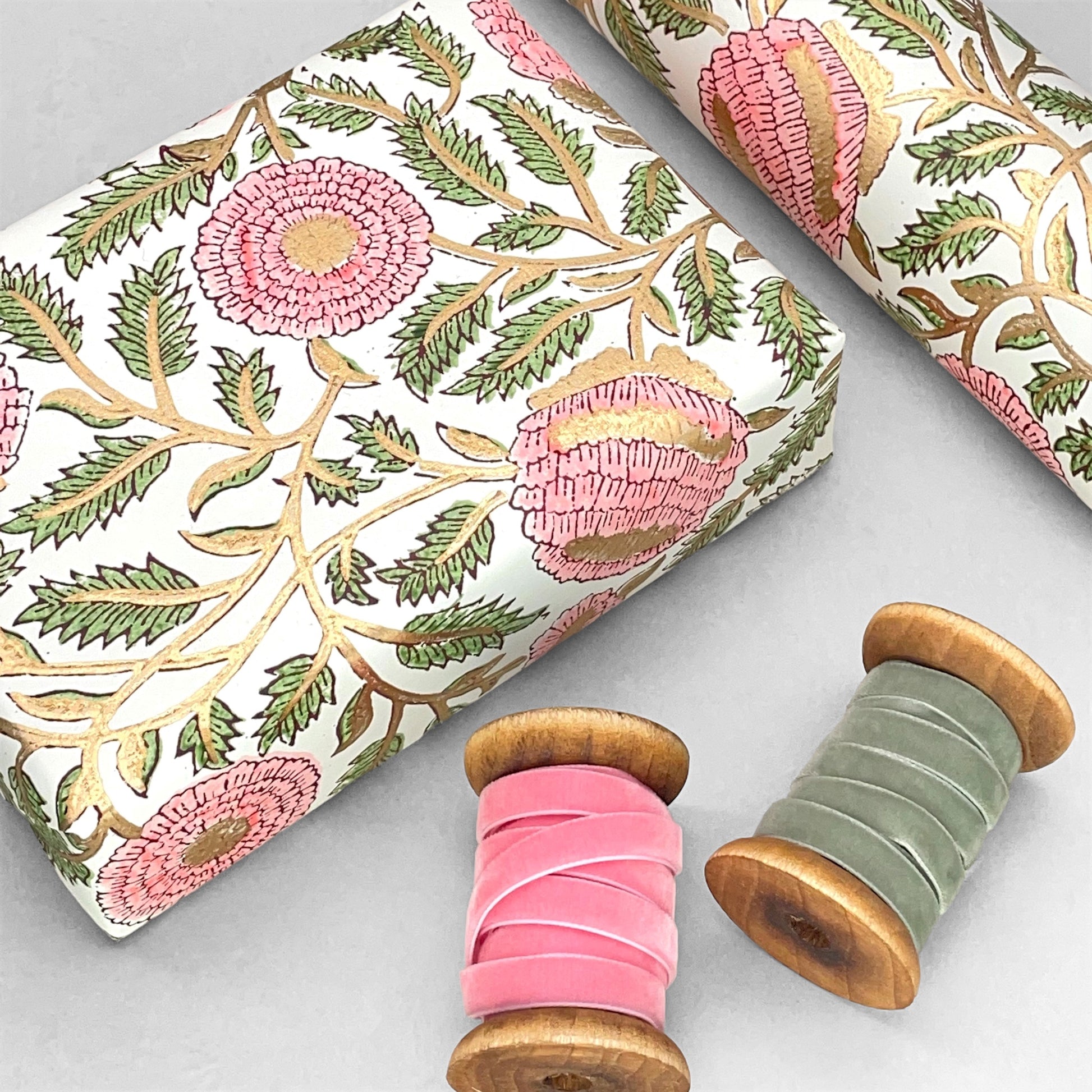 wrapping paper with repeat botanical pattern in pink, gold and green by Paper Mirchi