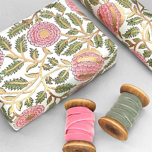 wrapping paper with repeat botanical pattern in pink, gold and green by Paper Mirchi