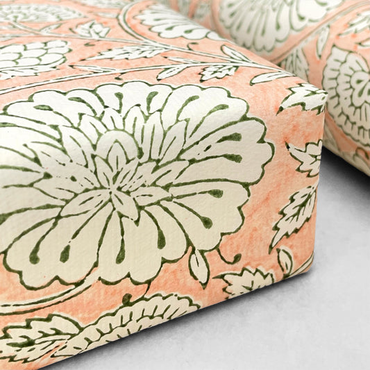 wrapping paper with repeat botanical pattern in light coral pink by Paper Mirchi