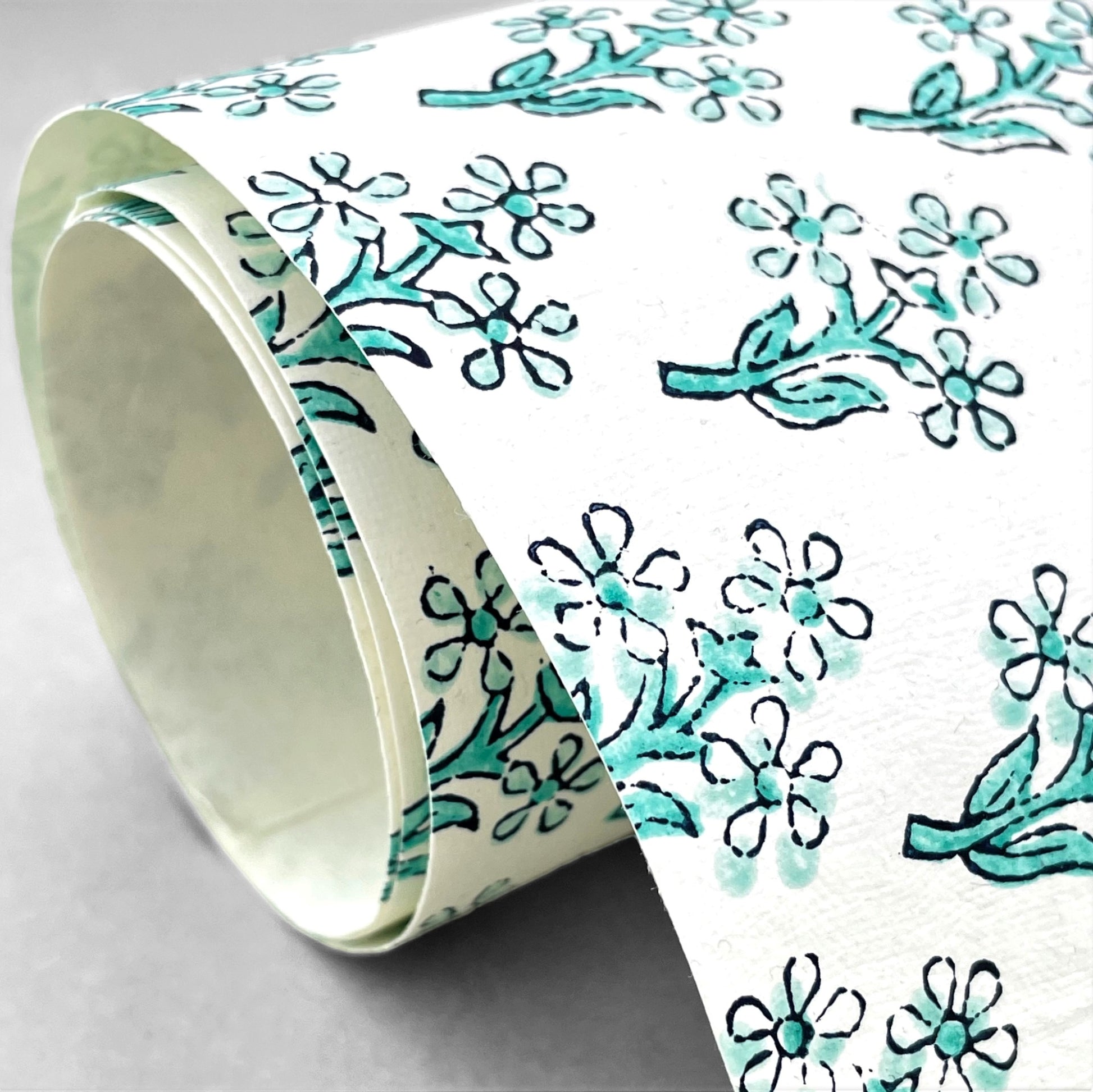 wrapping paper with repeat block print little floral pattern in aqua by Paper Mirchi