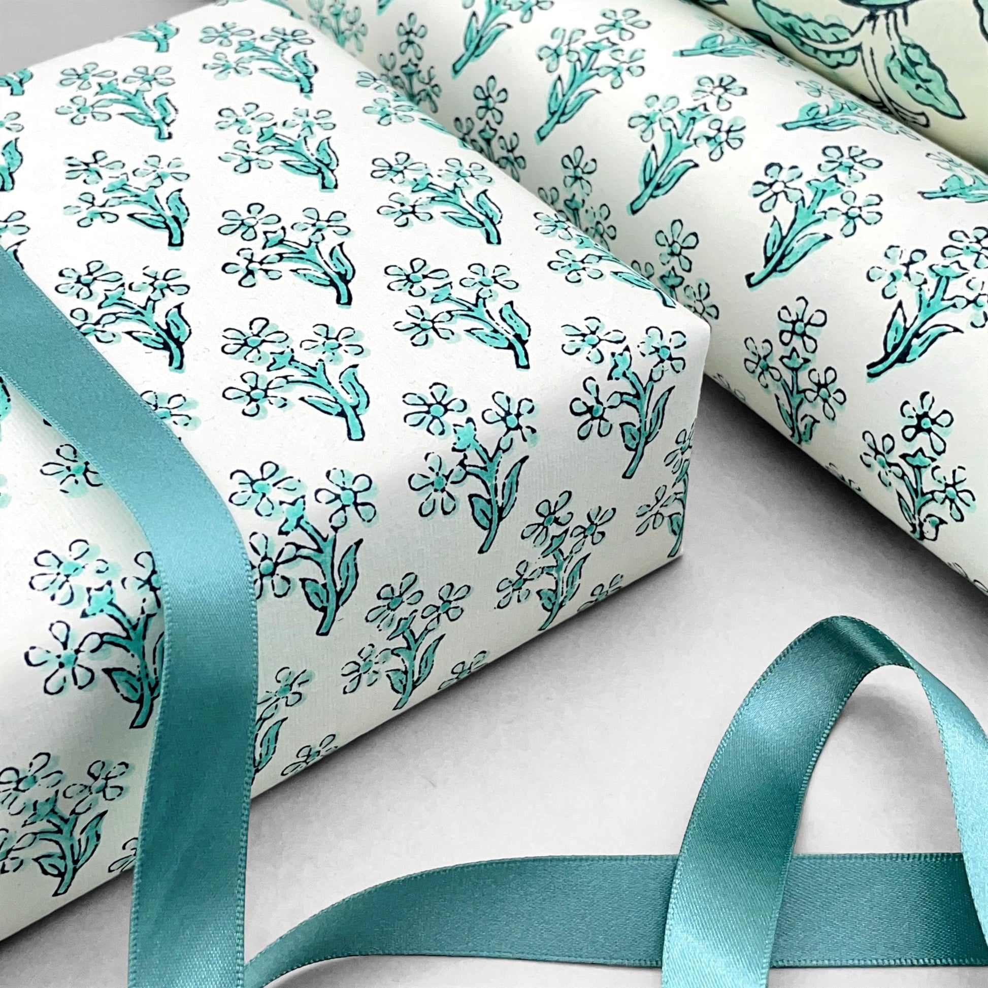 wrapping paper with repeat block print little floral pattern in aqua by Paper Mirchi