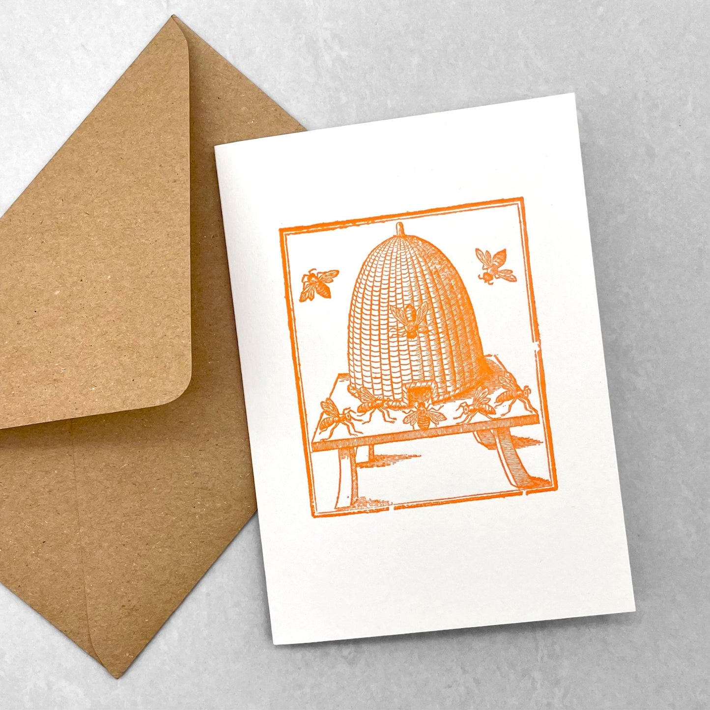 letterpress greetings card of a drawing of a bee hive, orange ink on white by Passenger Press