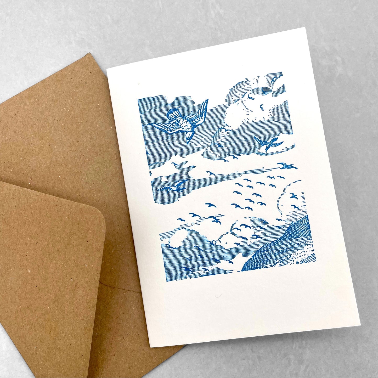 letterpress greetings card of a drawing of birds flying over the bass rock, blue ink on white by Passenger Press