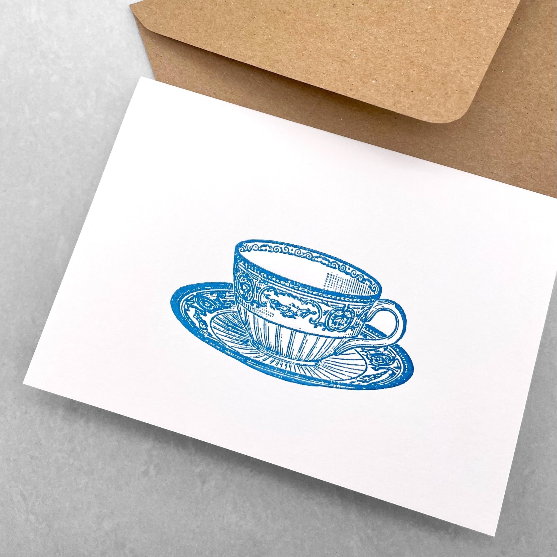 letterpress greetings card of a drawing of a wedgewood teacup and saucer, blue ink on white by Passenger Press