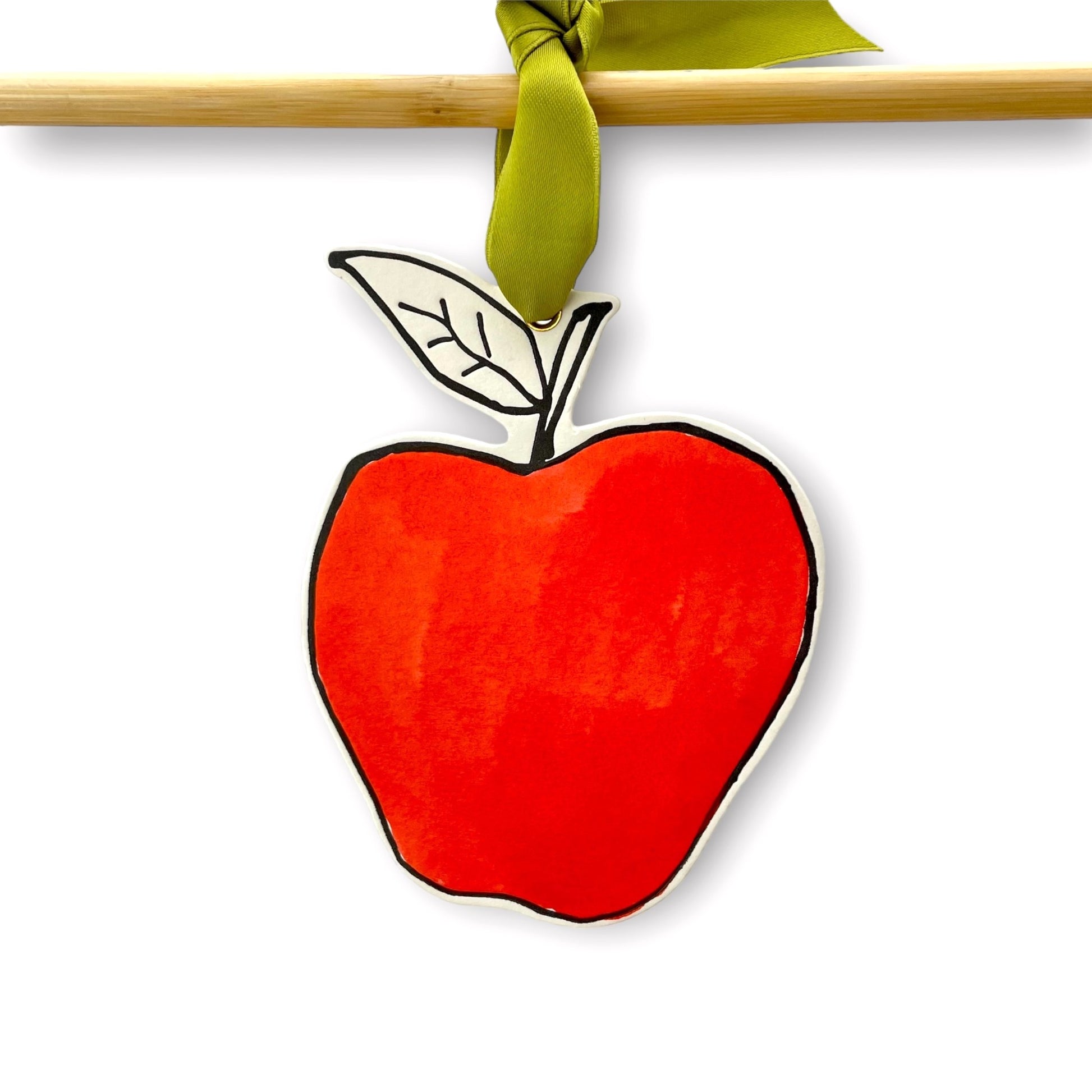 an apple shaped hanging ornament made of thick 1050gsm off-white card, letterpress printed in black and then hand painted in bright red ink. It has a chartreuse green satin ribbon to hang the ornament with. By Scribble & Daub.