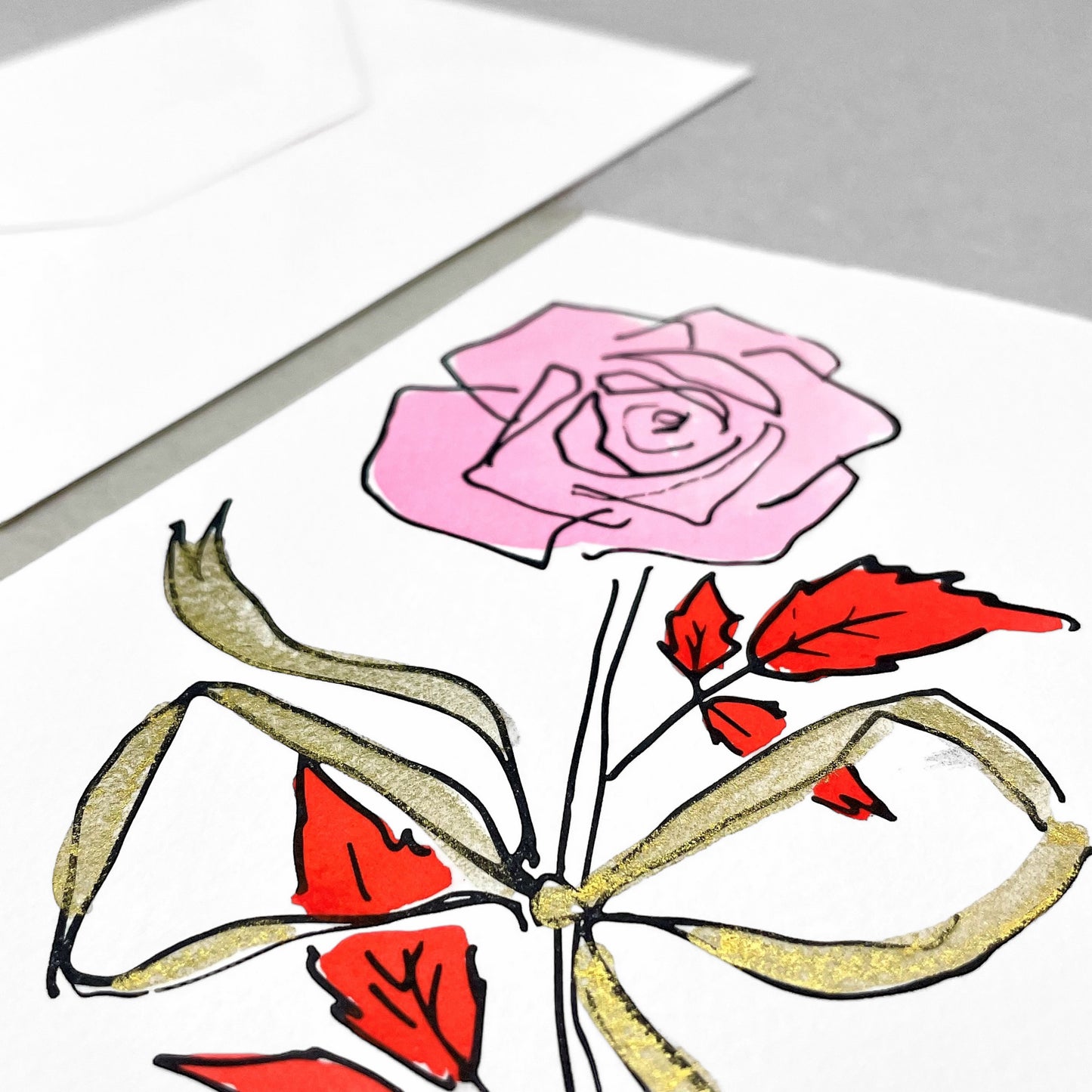 hand-painted greetings card of a pink rose tied with a gold ribbon, by Scribble and Daub