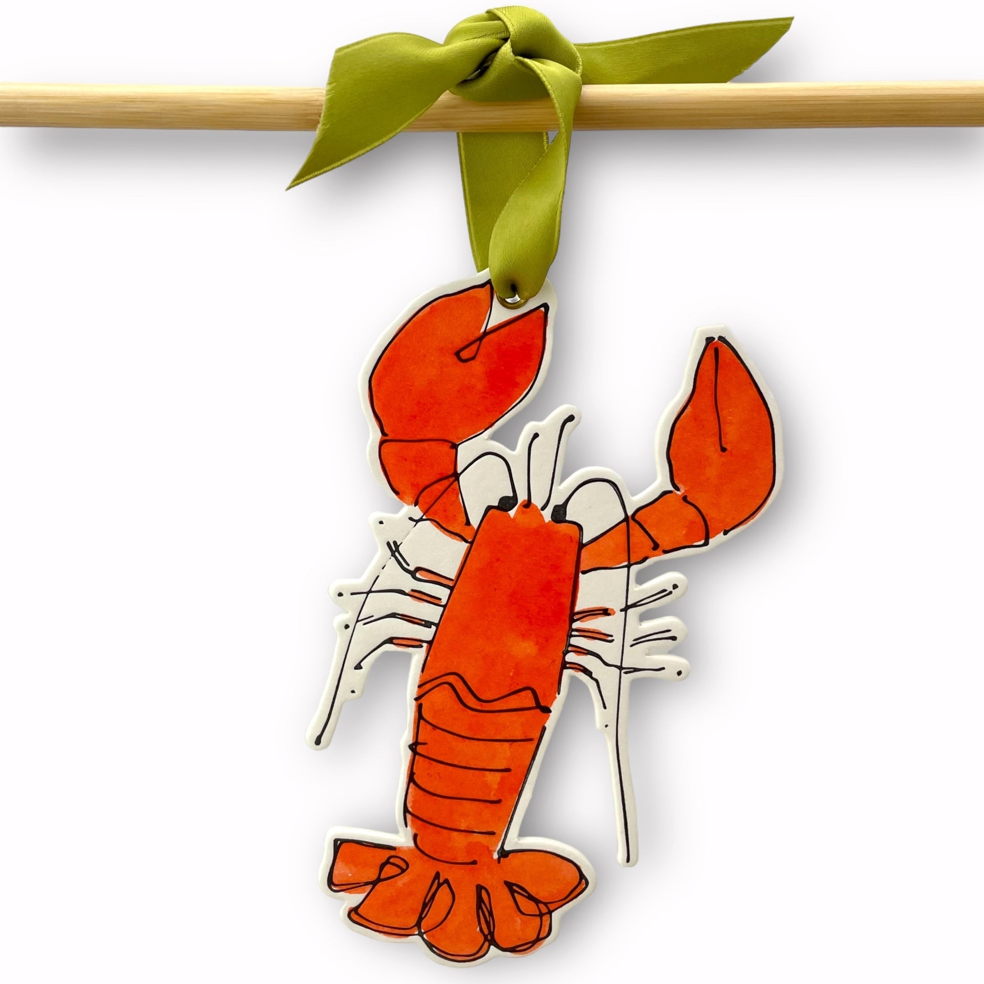 a lobster shaped hanging ornament made of thick 1050gsm off-white card, letterpress printed in black and then hand painted in orange ink. It has a chartreuse green satin ribbon to hang the ornament with. By Scribble & Daub.