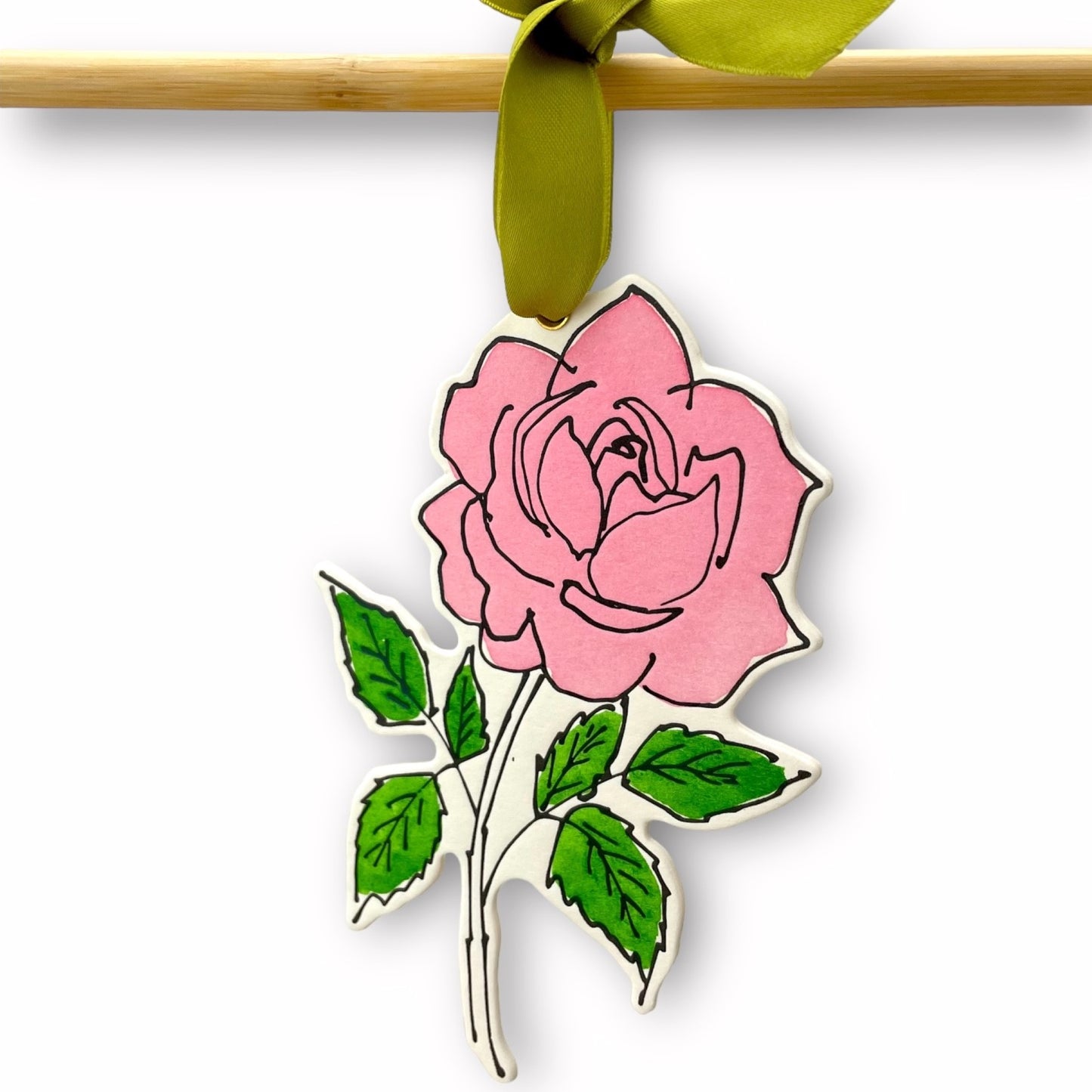 a rose shaped hanging ornament made of thick 1050gsm off-white card, letterpress printed in black and then hand painted in pink and green ink. It has a chartreuse green satin ribbon to hang the ornament with. By Scribble & Daub.