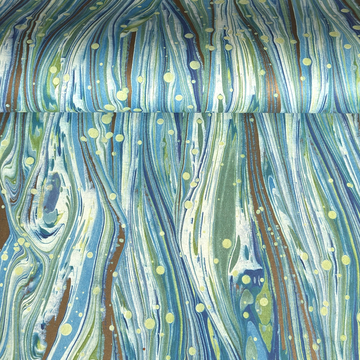 a sheet of Italian printed marbled wrapping paper by Tassotti with a marble pattern in aqua, blue, green, white an gold