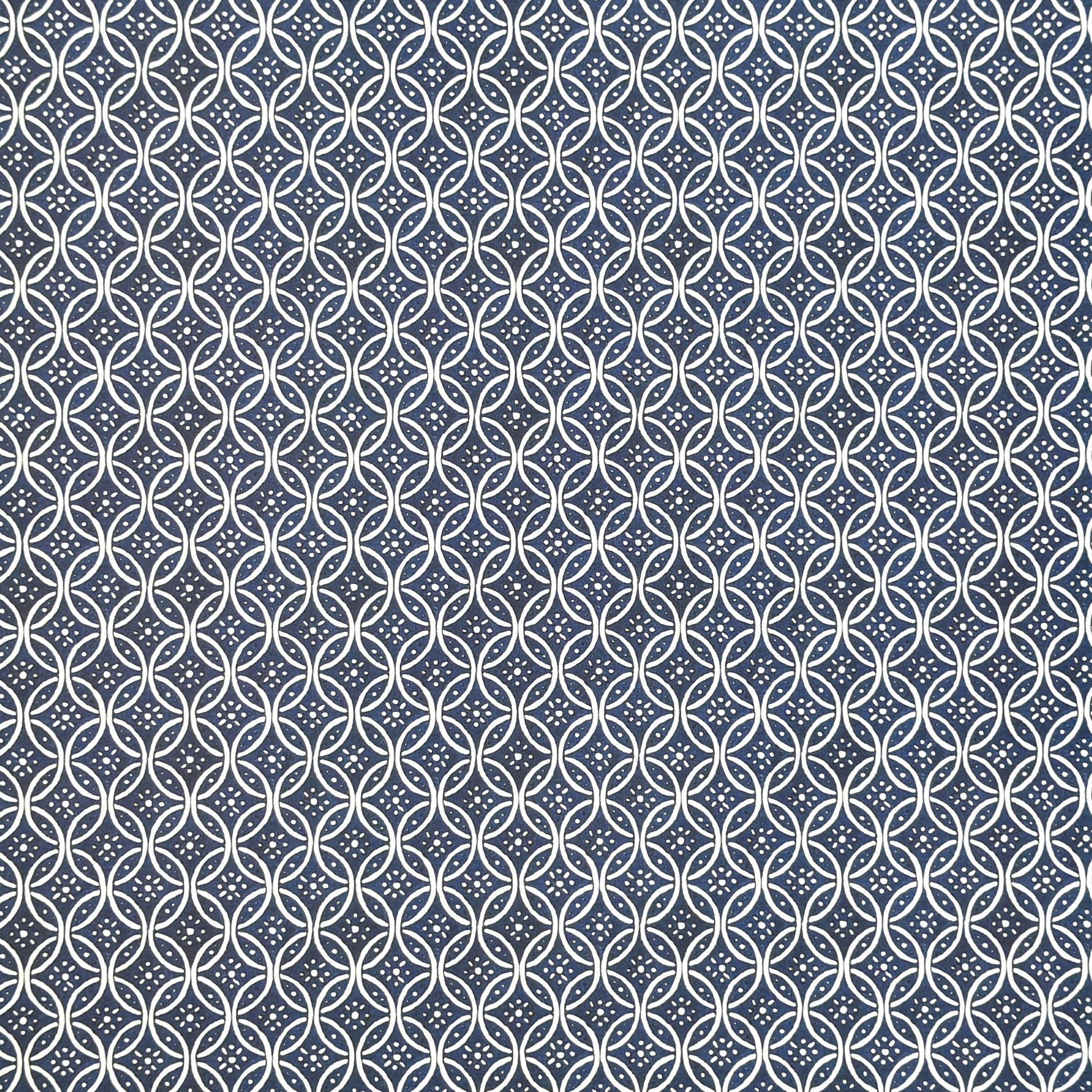 A sheet of Italian wrapping paper with a pattern of interlocking rings on a blue background.