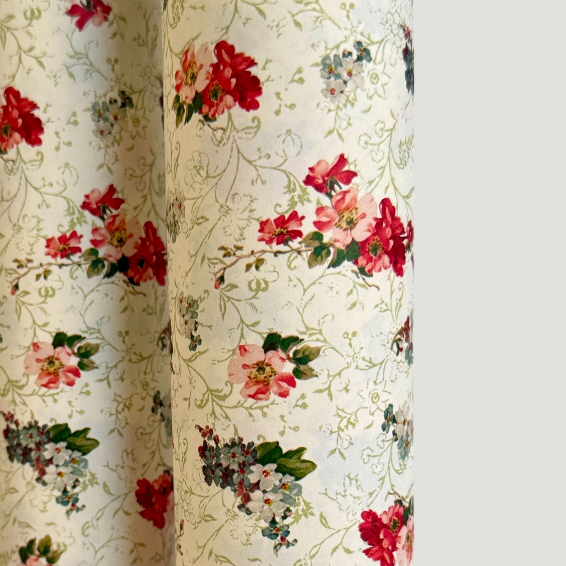 a sheet of italian wrapping paper with a vintage Liberty style floral pattern in red and green on cream